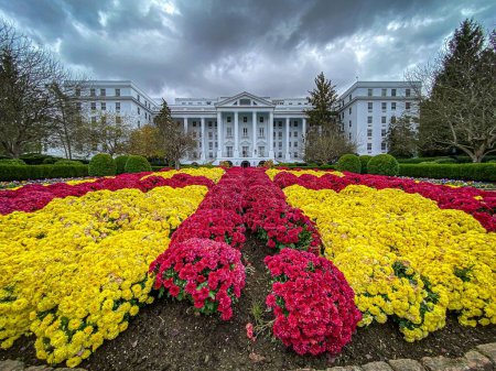 Téléchargez les photos : Le pittoresque complexe de luxe Greenbrier avec une cour pleine de fleurs - en image libre de droit
