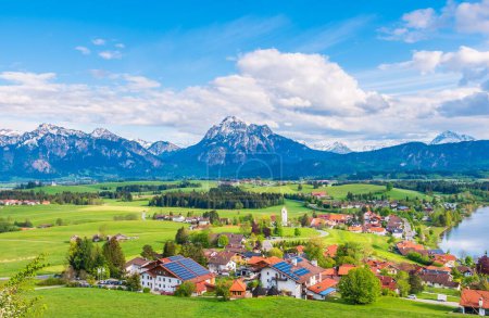 Photo for A peaceful scenery of a countryside settlement with alpine mountains in the background - Royalty Free Image
