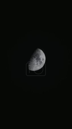Photo for A vertical shot of the moon in a black sky - perfect for wallpaper - Royalty Free Image