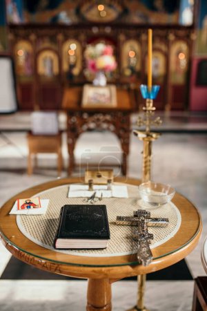 Photo for A vertical shot of the Bible and cross on the church table - Royalty Free Image