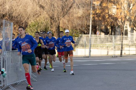 Photo for Madrid, Spain, -December,31,2022, popular race of San Silvestre through the streets of the city, where old people, young people and with a lot of colo - Royalty Free Image