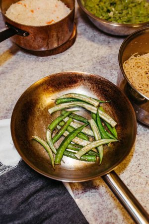 Photo for A high-angle shot of the Green Beans being fried on the pan on the blurred background - Royalty Free Image