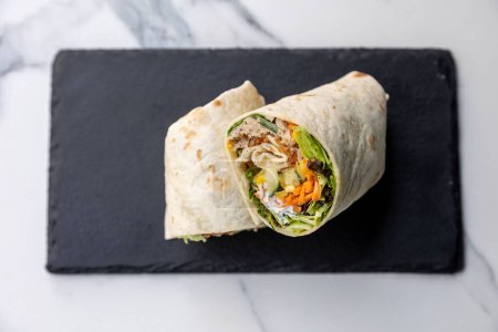 Photo for A closeup of lavash roll with meat and vegetables - Royalty Free Image
