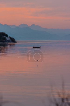 Photo for A vertical shot of a kayak in a lake during a sunset - Royalty Free Image