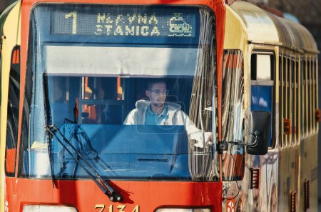 Photo for A young male tram driver going to the main train station on a sunny day in Bratislava, Slovakia - Royalty Free Image