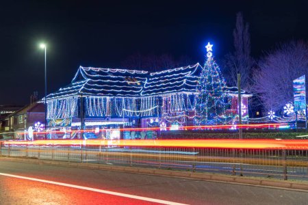 Photo for The 'Daft As a Brush' cancer patient transport charity's building lit up for Christmas - Royalty Free Image