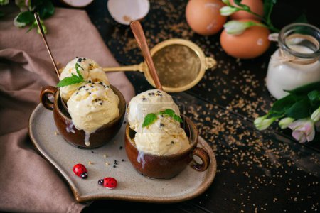 Photo for Homemade vanilla ice served lovely on a heratplate, decorated with eggs and two ladybugs. - Royalty Free Image