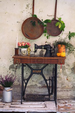 Photo for Old vintage sewing maschine used as decoration to make the garden more beautiful and emotional - Royalty Free Image