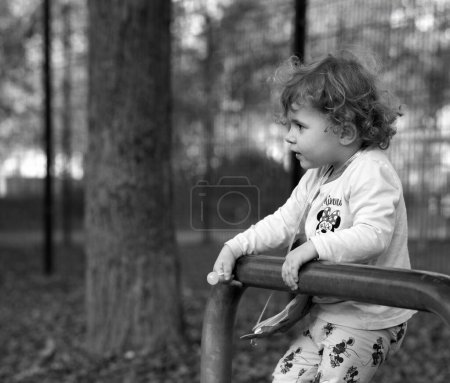 Photo for A cute little girl is holding a lollipop and is very happy in Halle an der Saale, Saxony-Anhalt, Germany - Royalty Free Image