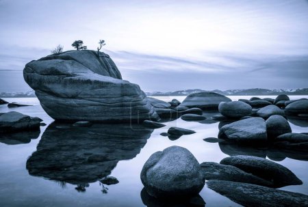 Photo for The reflection of Bonsai Rock on the Nevada side of Lake Tahoe against the evening sky - Royalty Free Image