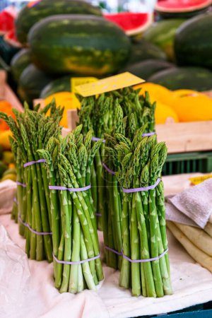 Photo for A vertical shot of a bunch of green fresh asparagus at the local market in Bamberg Germany - Royalty Free Image