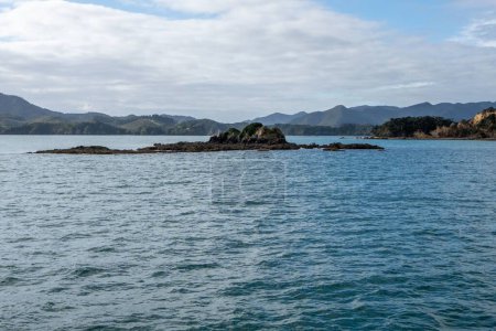 Téléchargez les photos : Une vue sur le paysage marin ensoleillé avec un ciel nuageux, Baie des îles - en image libre de droit