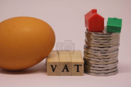 Photo for Wooden cube block with VAT text with Sri Lanka rupee coins ,,houses ,an egg. Selective focus.Financial, Management, Economic, business concept - Royalty Free Image