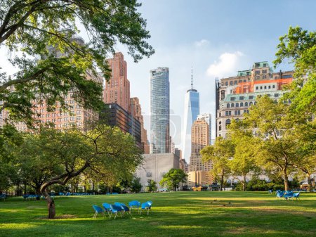 Téléchargez les photos : Une vue panoramique des chaises bleues vides dans le parc de batterie vert à New York, États-Unis. - en image libre de droit