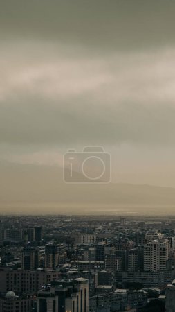 Photo for A vertical shot of the dark clouds over the cityscape - Royalty Free Image