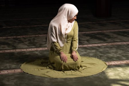 Photo for A portrait of a gorgeous humble Muslim woman praying in peace at a mosque - Royalty Free Image