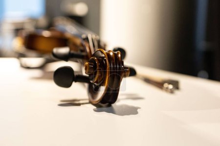 Photo for A close-up shot of a violin on a white table - Royalty Free Image