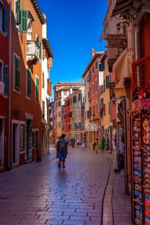 Photo for A vertical of people walking in the streets of Rovinj in the morning - Royalty Free Image