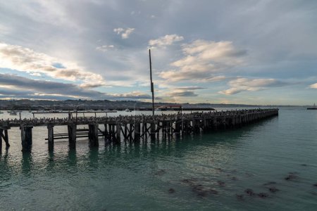 Photo for A drone shot of a wooden dock on the lake surface under the cloudy sky in New Zealand - Royalty Free Image