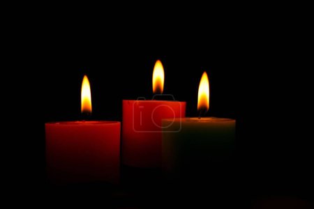 Photo for A beautiful shot of lit candles on a black background - Royalty Free Image