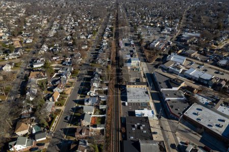 Foto de Una vista aérea sobre un barrio comercial en Long Island, NY en un día soleado con una línea de tren - Imagen libre de derechos