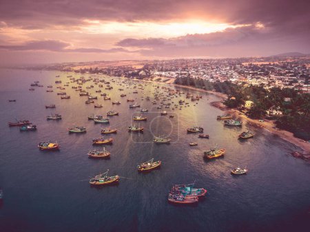 Photo for An aerial view of boats in the sea at sunset - Royalty Free Image