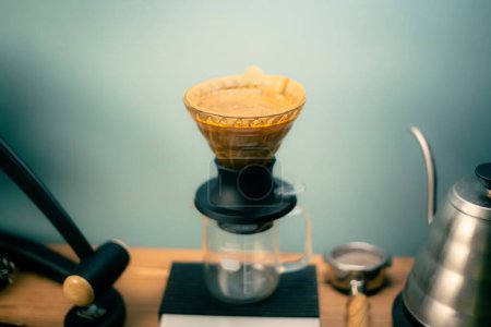 Photo for The Hario V60 Immersion Dripper preparing coffee on the blurred background - Royalty Free Image
