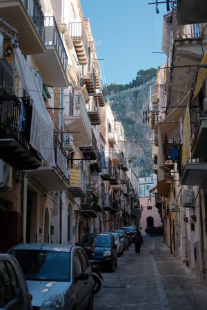 Photo for A scenic street view with a mountain in the background in Cefalu, Italy - Royalty Free Image