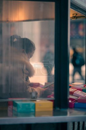 Photo for A vertical shot of a customer service worker through a window in Shanghai, China - Royalty Free Image
