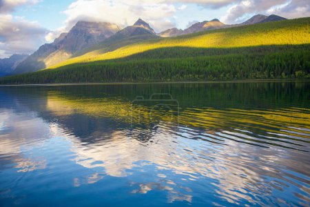 Téléchargez les photos : Le lac Bowman contre les collines verdoyantes du parc national des Glaciers - en image libre de droit