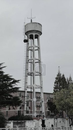 Photo for The picture was took in Shanghai. It is an abandoned water tower. The paint on it is peeling off. It is a witness of the development of this city. - Royalty Free Image