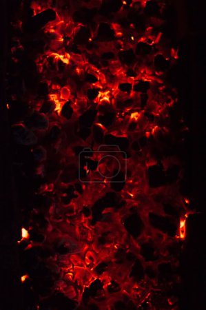 Photo for A vertical top view closeup of hot smoldering ashes form a fire - Royalty Free Image