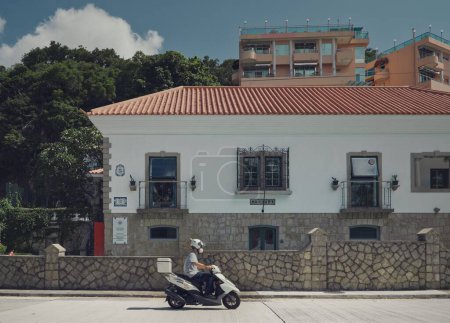 Photo for A closeup of a scooterist on a building background - Royalty Free Image