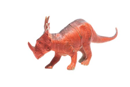 Photo for An old and worn toy Styracosaurus isolated on a white background. - Royalty Free Image
