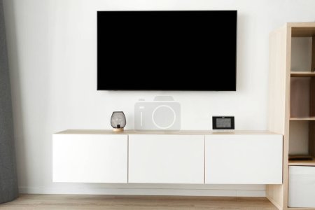 Cozy living room shot of tv with horizontal screen mockup. High quality photo