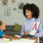 A little boy learns the letter A with a private English tutor during a lesson at home. High quality photo