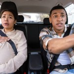 Young pregnant african american woman shouting, feeling pain and contractions while her worried and shocked husband driving car