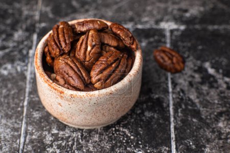 Photo for Pecan nuts on a rustic wooden table and pecan nuts in bowl. Free space for your text. - Royalty Free Image