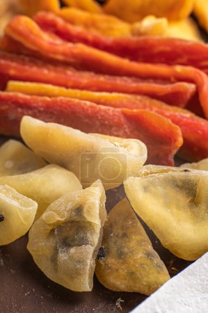 Photo for Dried sweet papaya sticks and dried passion fruit. Candied fruits. Top view. - Royalty Free Image