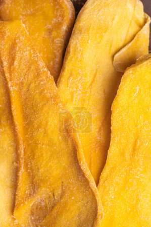 Photo for Slices of large sweet dried mangoes. Close up macro. Top view. - Royalty Free Image