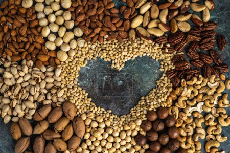 Photo for Assorted nuts with a heart in the middle of the composition. Healthy organic food. - Royalty Free Image