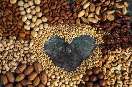 Photo for Assorted nuts with a heart in the middle of the composition. Healthy organic food. - Royalty Free Image