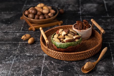 Photo for Various Nuts in wooden bowl on dark background. Free space for your text. - Royalty Free Image