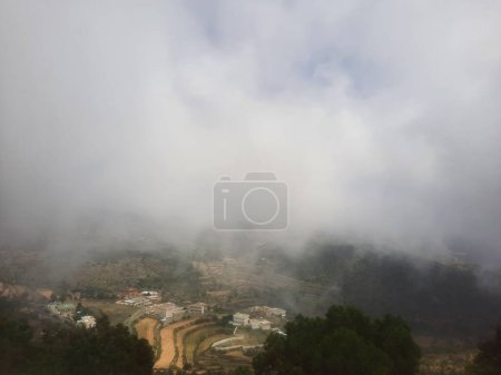 Photo for Breathtaking natural beauty of Abha in Saudi Arabia in the summer season. High mountains, greenery, low clouds and fog are the beauty of Abha. - Royalty Free Image