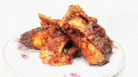 Balado Tuna Fish dish on a white background. This Padang-style dish is very popular because of its delicious spicy taste