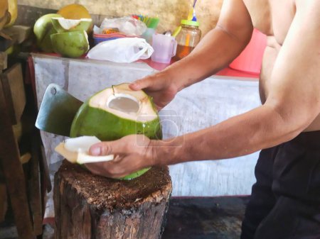 Young coconut sellers are peeling young coconuts for water and flesh