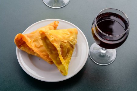 Photo for Traditional Middle East snack fried stuffed samosa pie with vegetables served with red wine - Royalty Free Image