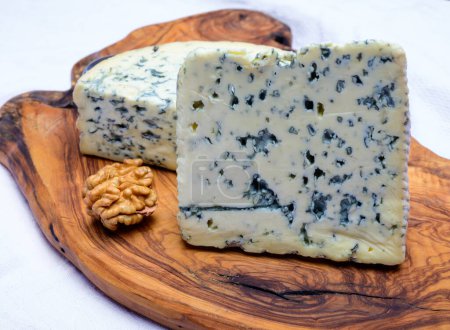 Photo for Cheese collection, piece of French blue cheese auvergne and fourme d'ambert close up - Royalty Free Image
