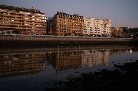 Photo for Evening walk along river in central part of Donostia or San Sebastian city, Basque Country, Spain in winter - Royalty Free Image
