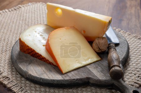 Photo for Cheese collection, tasty Belgian abbey cheeses made with brown trappist beer close up - Royalty Free Image